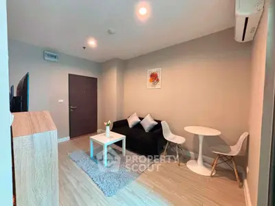 Modern living room with cozy seating and stylish decor in a contemporary apartment.
