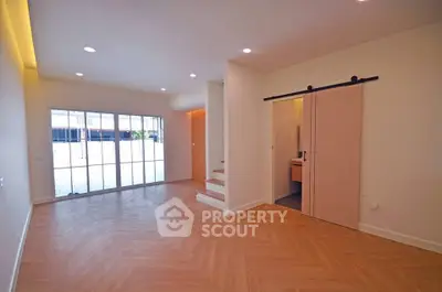 Spacious modern living room with sliding door and natural light