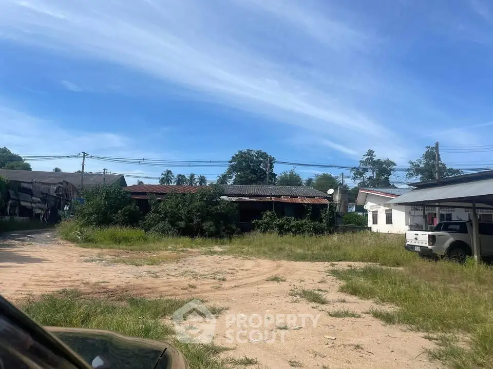 Explore potential with this spacious plot featuring rustic buildings and lush greenery, perfect for development opportunities.