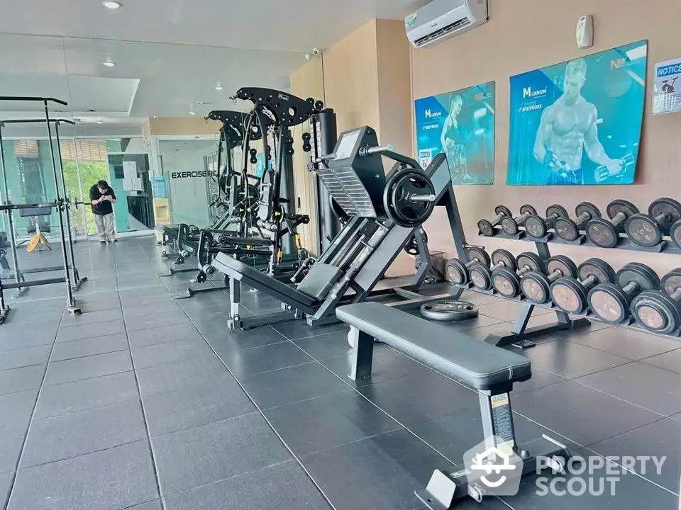 Modern gym with state-of-the-art equipment and sleek design in a luxury residential building.