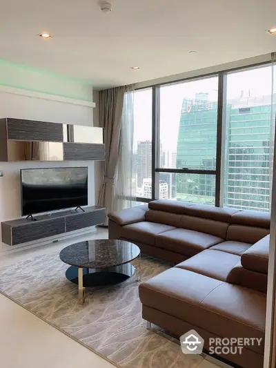 Modern living room with large windows and city view, featuring sleek furniture and contemporary design.