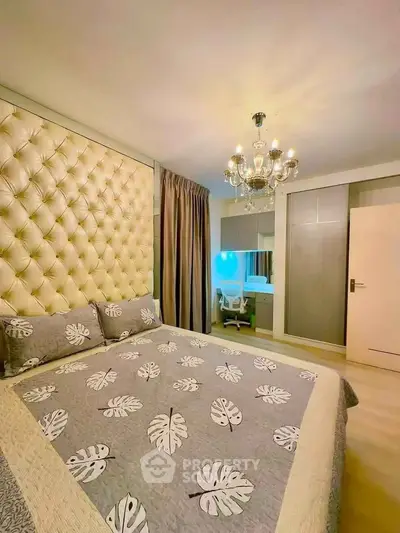 Luxurious bedroom with elegant chandelier and tufted headboard