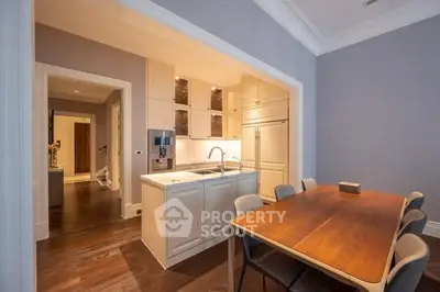 Modern kitchen with open layout and elegant dining area in luxury apartment.