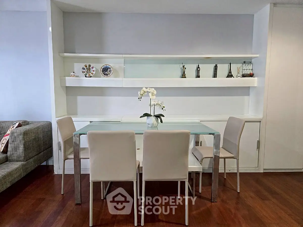 Modern dining area with glass table and elegant decor in a stylish apartment