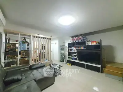 Spacious living room with modern decor and ample natural light