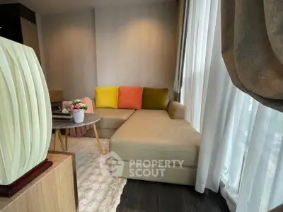 Stylish living room with modern beige sofa and colorful cushions, perfect for relaxation and entertaining.