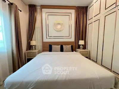 Luxurious bedroom with elegant decor and ample natural light, featuring a large bed and stylish curtains.