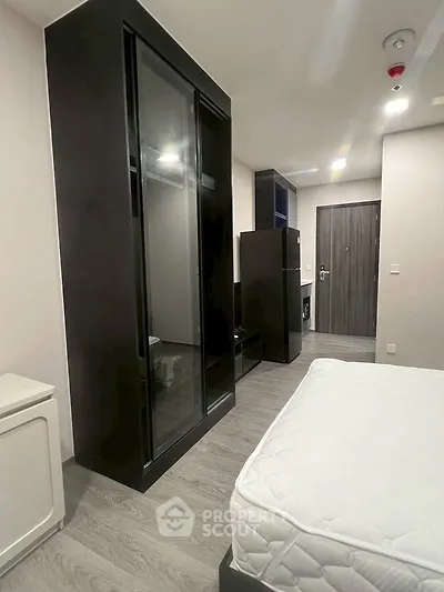 Modern bedroom with sleek black wardrobe and minimalist design