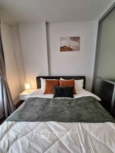 Cozy bedroom with modern decor and soft lighting, perfect for relaxation.