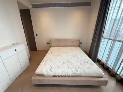 Modern bedroom with minimalist design and large window view.