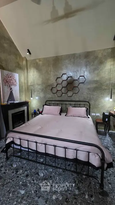 Luxurious bedroom with elegant decor and modern furnishings, featuring a stylish metal bed frame and artistic wall design.