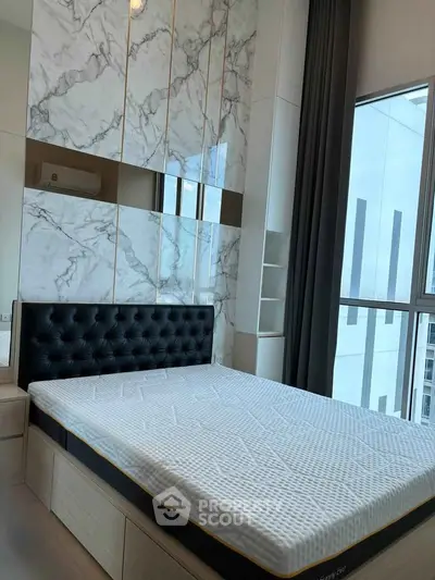 Luxurious bedroom with modern marble accent wall and large window view