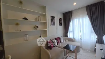 Stylish living room with modern decor and natural light, featuring a cozy sofa and elegant shelving.
