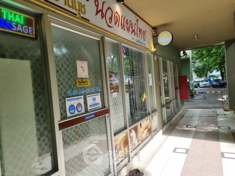 Commercial property exterior with glass storefront and signage in urban setting