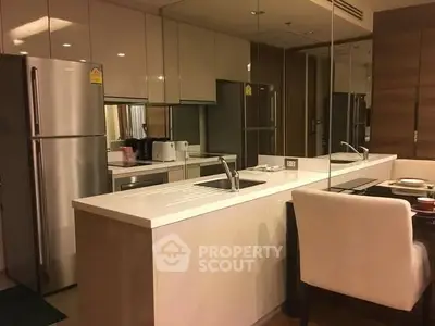 Modern kitchen with sleek design, featuring stainless steel appliances and elegant dining area.