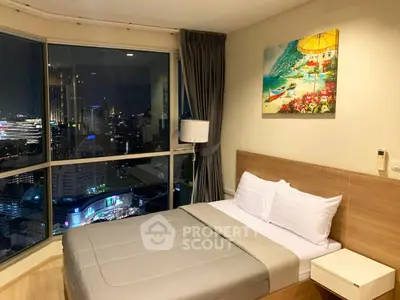Luxurious bedroom with stunning city view and modern decor in high-rise apartment.