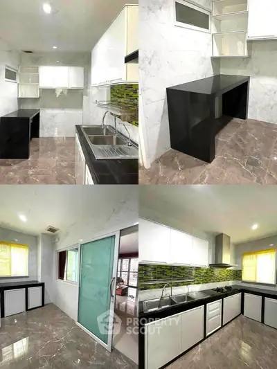 Modern kitchen with sleek black countertops and marble flooring, featuring a closed layout and ample storage.
