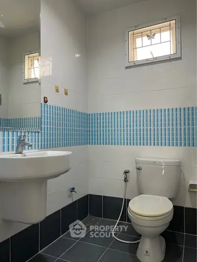 Modern bathroom with sleek fixtures and blue tile accents