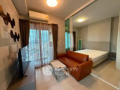 Modern studio apartment with stylish living area and cozy bedroom, featuring a sleek design and city view.
