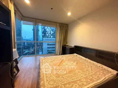 Spacious bedroom with city view in modern high-rise apartment
