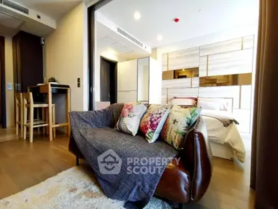 Modern living room with cozy sofa and stylish decor in open-plan apartment