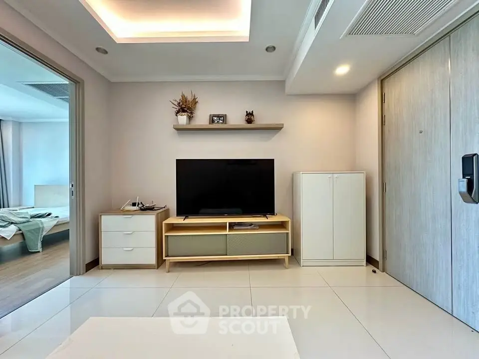 Modern living room with sleek TV stand and minimalist decor in a stylish apartment.