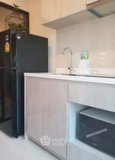 Modern kitchen with sleek cabinetry and built-in appliances in a stylish apartment.