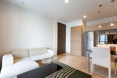 Modern living room with open kitchen and stylish decor in a cozy apartment.