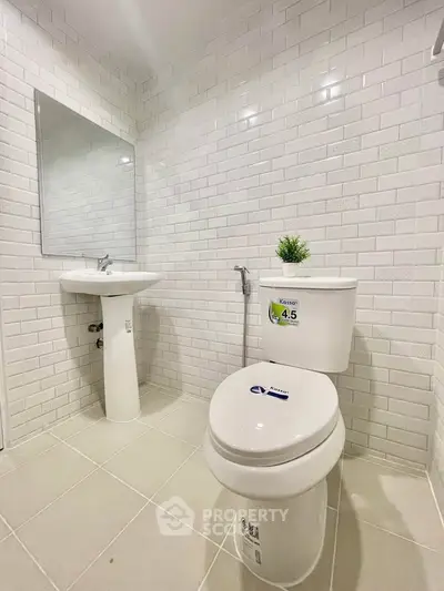 Modern bathroom with white subway tiles and sleek fixtures