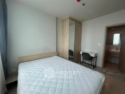 Modern bedroom with minimalist design featuring a comfortable bed and sleek furniture.
