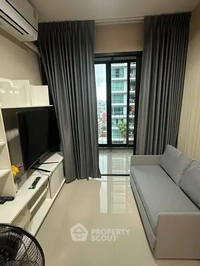Modern living room with sleek design, featuring a large window with city view, stylish sofa, and entertainment unit.