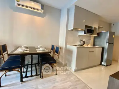 Modern kitchen and dining area with sleek appliances and stylish furniture