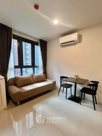 Modern living room with cozy sofa and dining area in a high-rise apartment.