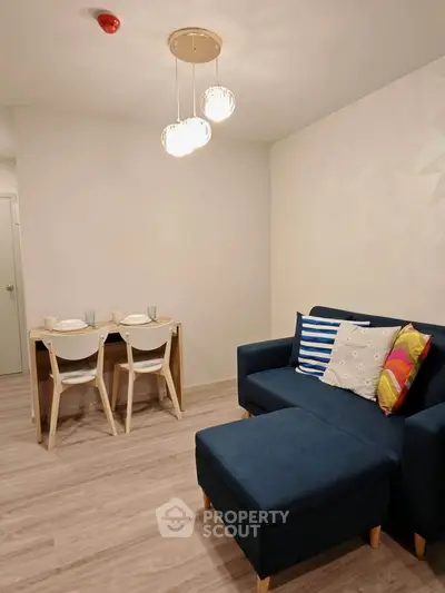 Modern living room with stylish furniture and elegant lighting, perfect for cozy gatherings.