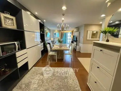 Elegant living room with modern decor and dining area in open layout apartment.