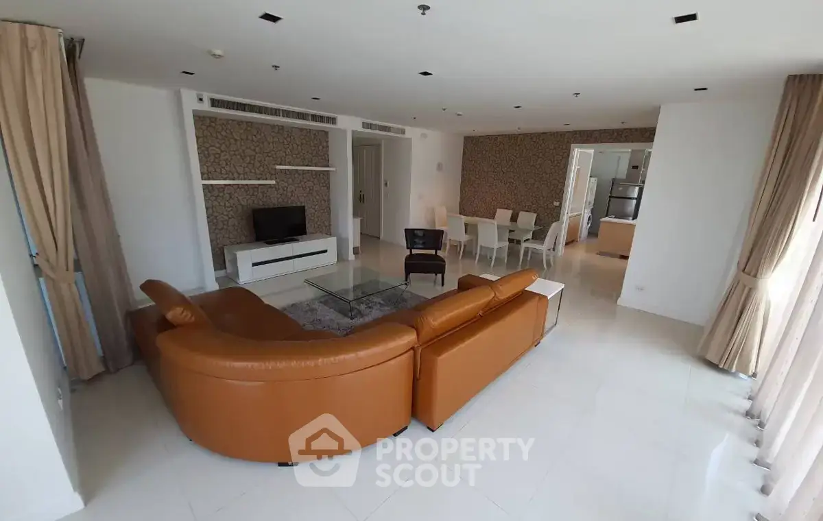 Spacious living room with modern furniture and open layout in a luxury apartment.