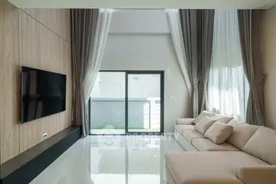 Spacious modern living room with high ceilings and elegant decor