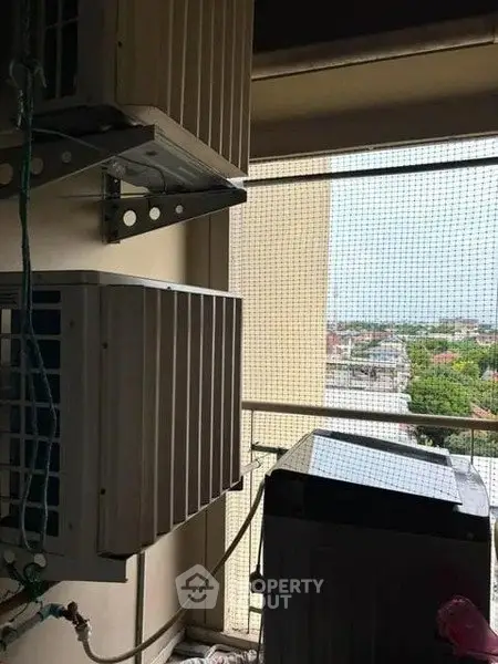 Balcony with air conditioning units and city view