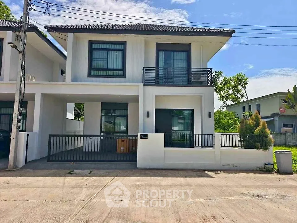 Modern two-story house with sleek design and spacious driveway in a serene neighborhood.