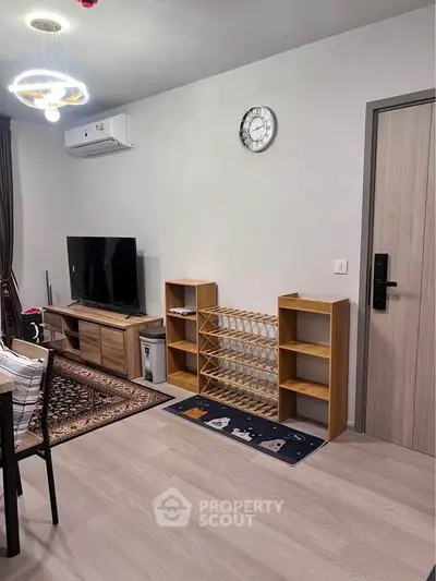 Modern living room with stylish furniture and wall-mounted TV, perfect for cozy evenings.