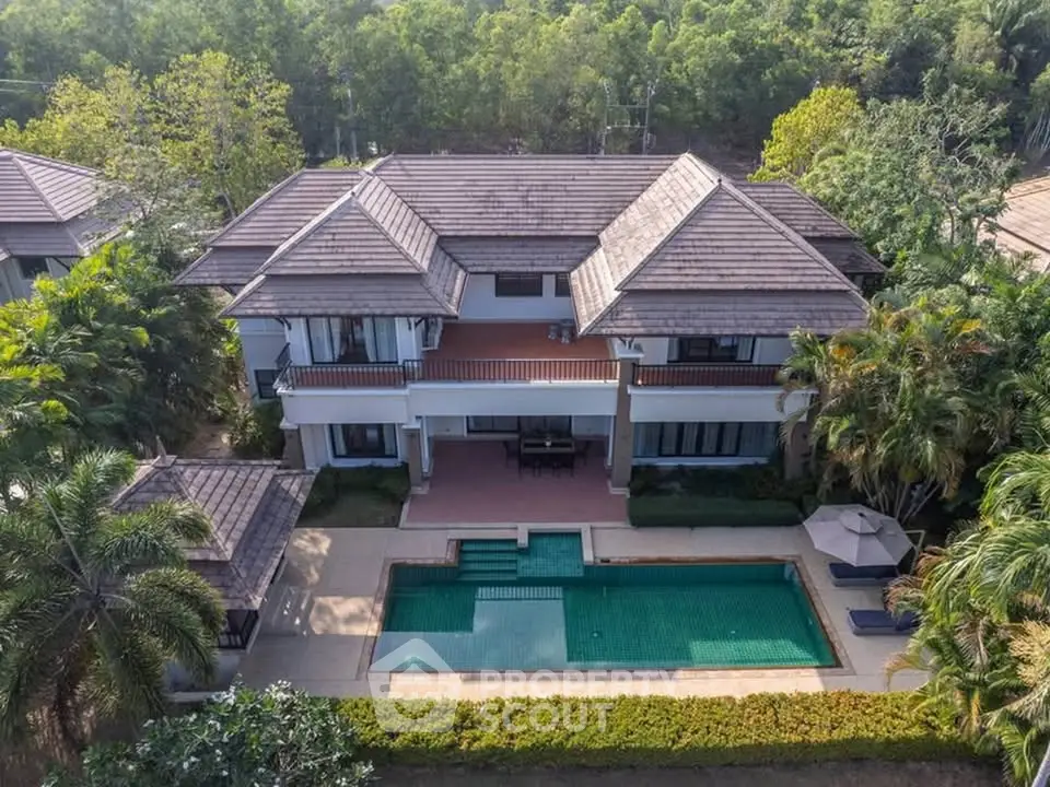 Luxurious villa with private pool and lush greenery, perfect for serene living.
