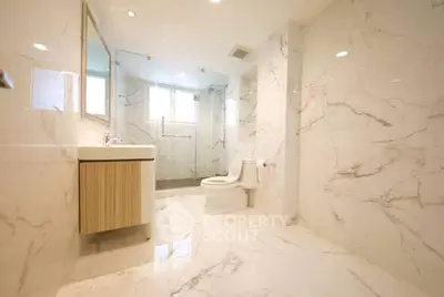 Luxurious marble bathroom with modern fixtures and spacious design.