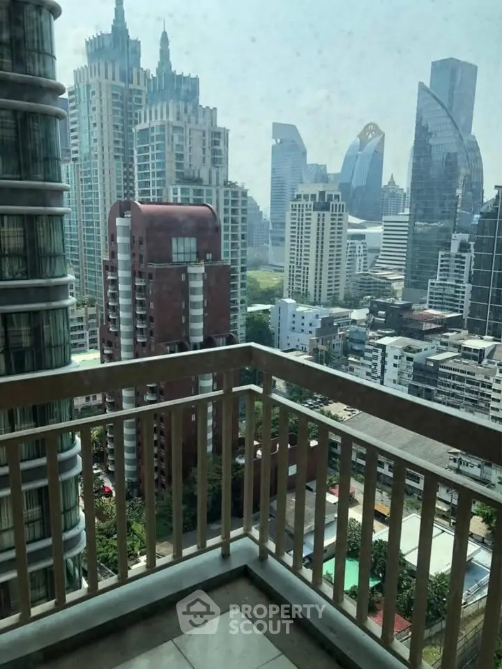 Stunning cityscape view from a high-rise balcony in a modern urban setting.