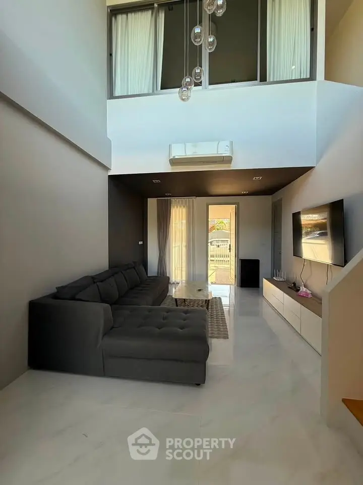 Spacious modern living room with high ceiling and elegant decor