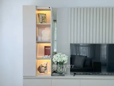 Modern living room with sleek TV unit and decorative shelving