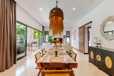 Luxurious open-plan living and dining area with elegant decor and garden view.