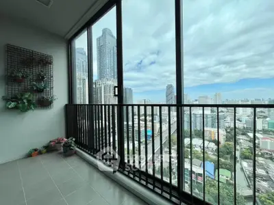 Spacious balcony with stunning city skyline view, perfect for relaxation and enjoying urban living.