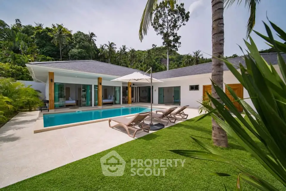 Luxurious villa with private pool and lush garden in tropical paradise setting.