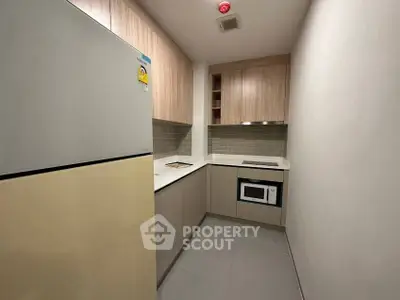 Modern compact kitchen with sleek cabinetry and built-in appliances