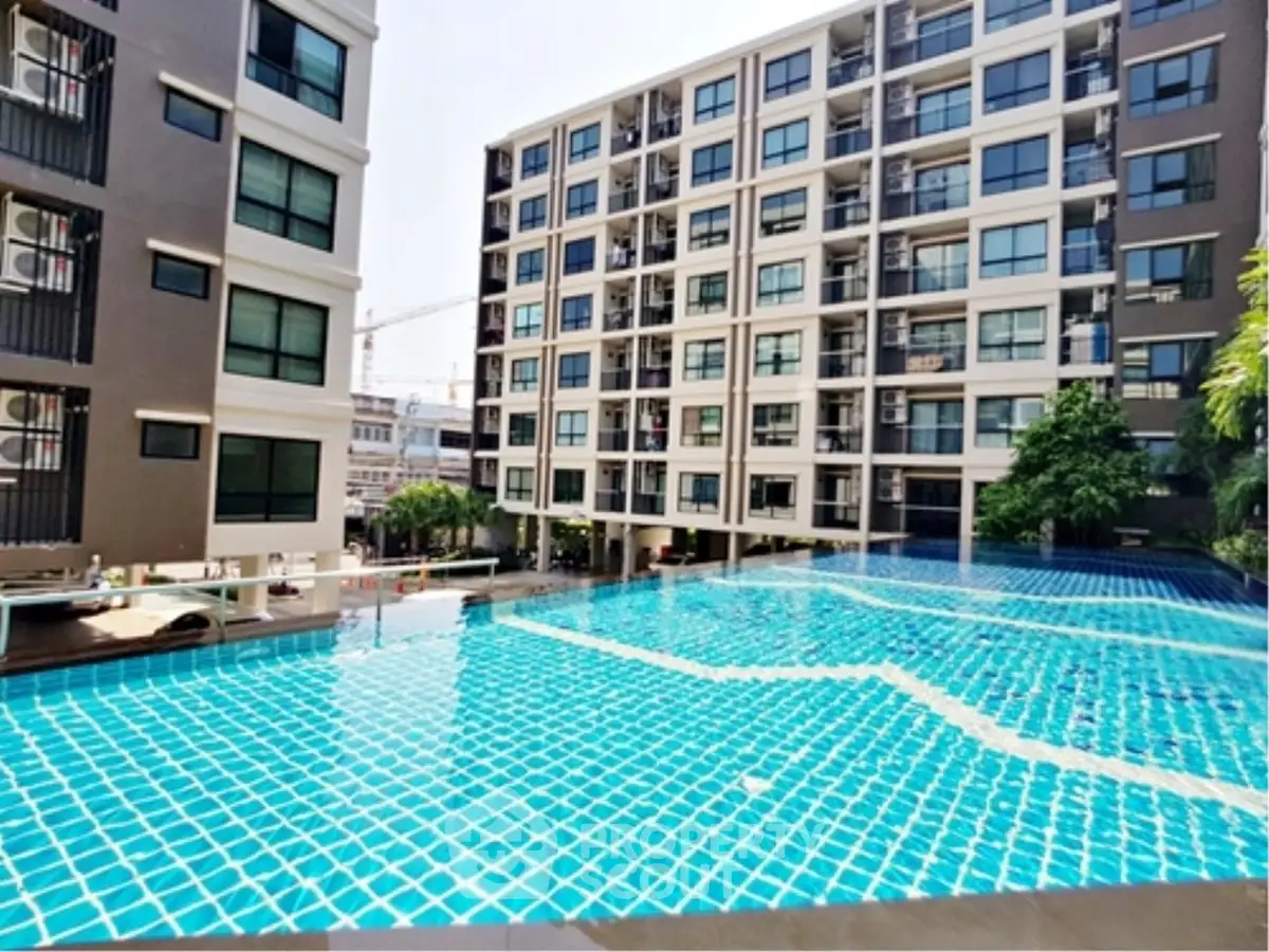 Modern apartment complex with a stunning outdoor pool and contemporary architecture.